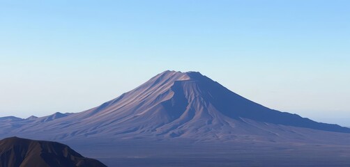 Fototapeta premium Majestic Teide volcano rises in the distance, a dramatic peak against a clear sky, height, nature