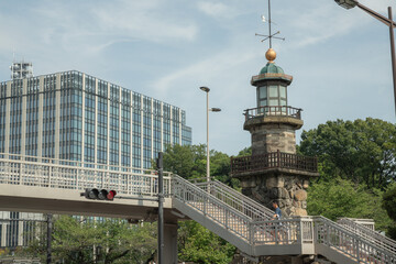 cityscape with foot bridge, modern buildings, and forest near the Nippon Budokan
