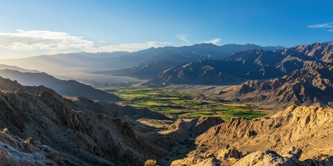 Fototapeta premium A majestic mountain range with soft sunlight casting long shadows over the valleys