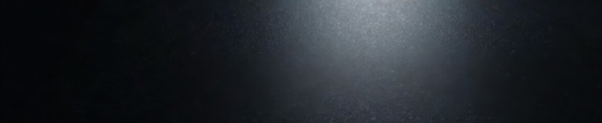 Smooth black metallic surface with subtle reflective sheen, polished, industrial