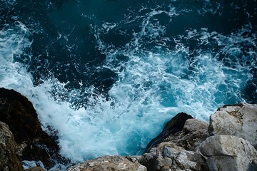 Ocean waves crashing on rocky cliffs coastline aerial view seascape natural beauty
