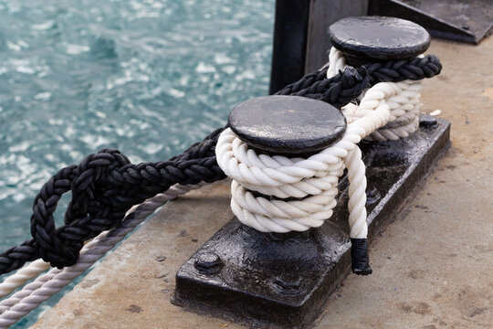 Black and white ropes tied off at a wharf