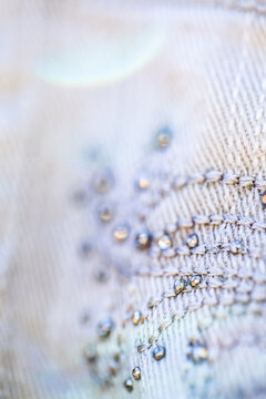 Diamante sparkles and threads making pattern on clothing