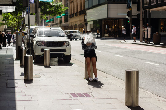 woman vaping in the street