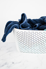 laundry basket full of bath towels, neatly folded, household and daily items concept