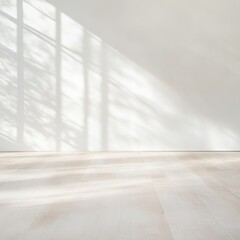 A bright, minimalistic room featuring light wood flooring and a white wall with shadow patterns