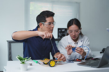 Engineers collaborating on a robotics project, building and programming a robot