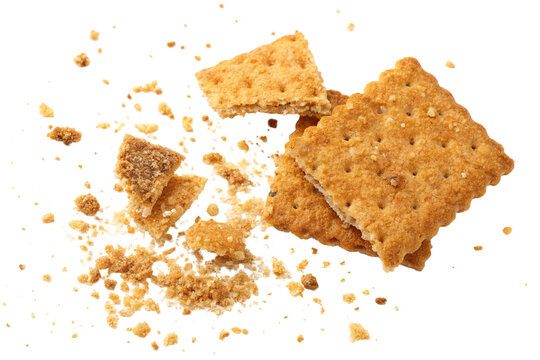 Crumbled graham crackers scattered on white background during a baking activity
