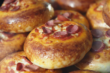 Deliciously baked bread rolls topped with hot dogs and cheese