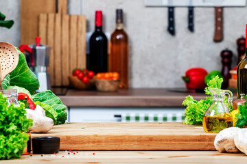 Healthy vegan eating, cooking, food blogging banner background with cutting board with lettuce, wine bottle, mushrooms and other vegetables and herbs on cozy kitchen with wooden table, kitchenware