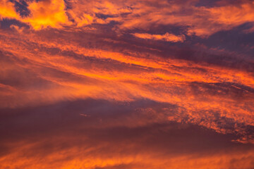 Stunning dramatic sunset sky with purple clouds and pink and red firmament texture