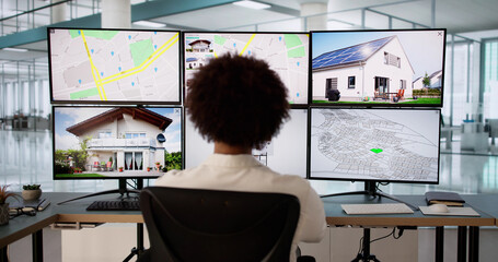 Young male real estate agent using computer