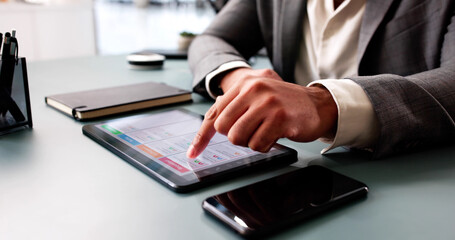 African American man using digital calendar schedule on tablet