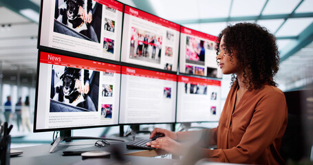 Woman Looking At News In Online Newspaper