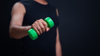 Close Up Hand Gripping Bright Green Dumbbell Intense Workout Exercise In Black Background, Highlighting Persons Lifestyle Of Strength Fitness Training