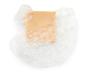 Beige soap with foam on white background, top view