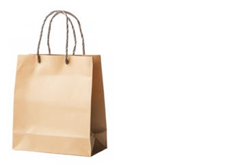 A simple tan paper shopping bag with rope handles isolated on a black and white background view