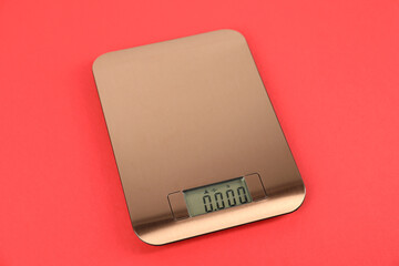 One electronic kitchen scale on red background, above view
