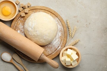Rolling pin and different ingredients on light table, flat lay
