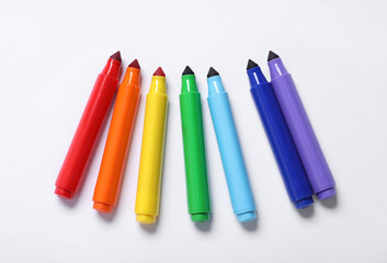 Many colorful markers on white background, flat lay