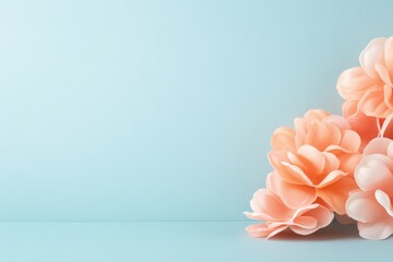 Artificial peach blossoms decorate a soft blue background space