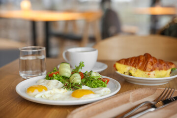 Delicious breakfast served on wooden table in cafe