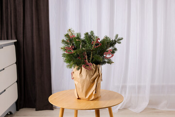 Beautiful Christmas composition of decorated fir tree branches on table indoors