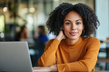Fototapeta premium Confident woman working on laptop in modern office