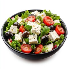 Fresh Greek salad with feta cheese, olives, tomatoes, and lettuce in a black bowl.