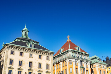 Obraz premium Stockholm Sweden - Traditional buildings on the waterfront of Stadsholmen, in Gamla stan, under deep clear blue sky.