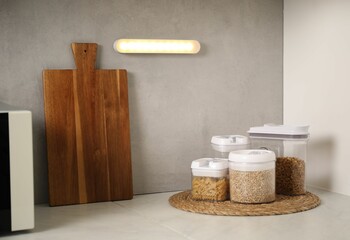 Glowing modern LED lamp on wall in kitchen