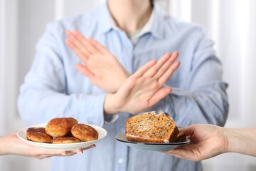 Woman refusing to eat products indoors, selective focus. Food allergy concept