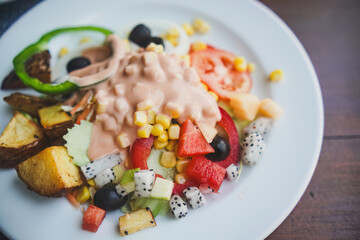 Fresh salad with sauce on a white plate. Healthy Eating