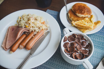 Breakfast with Fried Rice, Ham, Sausage, Cereal, and Pancakes. Food