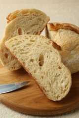 Slices of fresh bread on light textured table, closeup