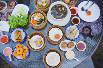 Overhead shot of assorted Dim Sum dishes on table, Asian food culture