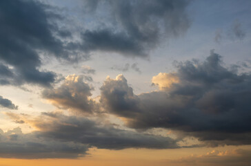Dramatic clouds at sunset, golden hour sky.