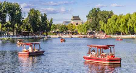Naklejka premium Red pedal boats on the Qianhai lake at the bell tower in Beijing, China