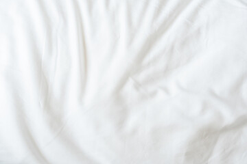 White bedsheet background, bed sheet texture, wrinkled duvet, crumpled satin blanket comforter cloth used in hotel, resort or home interior for bedding sleep comfort
