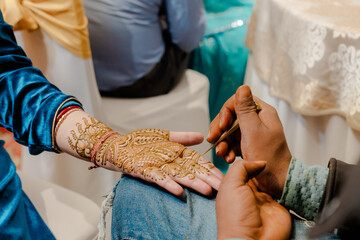 Close-up of intricate henna designs on hands, with palms facing up, showcasing beautiful