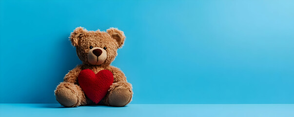 Teddy bear with heart on blue background