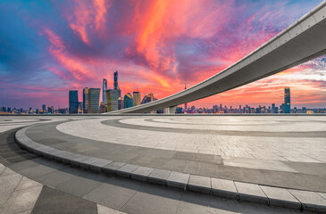 Fototapeta premium Empty floor with modern cityscape and bridge at sunset in Shanghai China