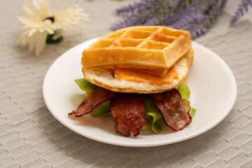 waffle with fried egg, bacon and sausage