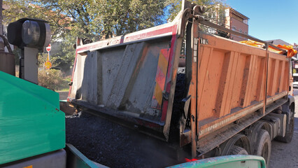 Heavy construction machines and truck outdoors for public street works.