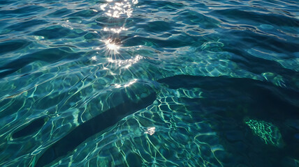 Fototapeta premium Tranquil Aerial Ocean Reflection: Clear Blue Sea Under Sunlit Tropical Scenery