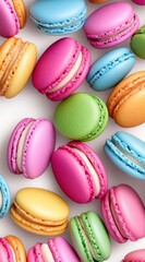 Fototapeta premium Assortment of colorful macarons scattered on a white background. Pastel shades, sweet treats, delicious, confectionery, close up.