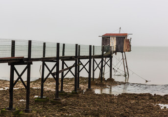 Charrelet fishing hut with the net set in the water on the Brittany coast, France.
