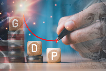 Double exposure of businessman writing decreasing arrow with USA flag and USD banknote for United...