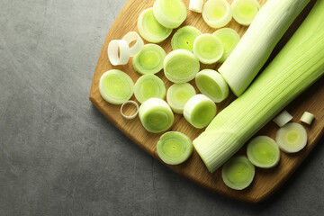 Fresh cut leeks on grey table, top view. Space for text
