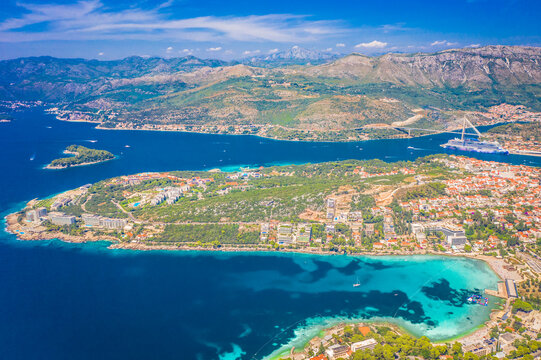 A breathtaking high-angle aerial view of Lapad Bay in Dubrovnik, Croatia, showcasing the stunning Adriatic coastline, deep blue waters, and the picturesque landscape of this iconic coastal destination